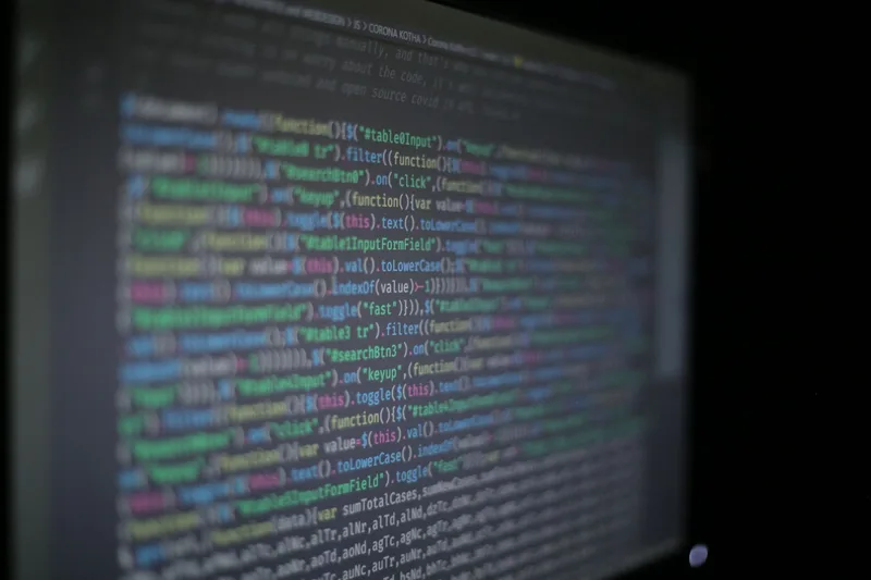 Close-up of colorful programming code on a dark computer screen, representing the AI models behind text-to-video generation
