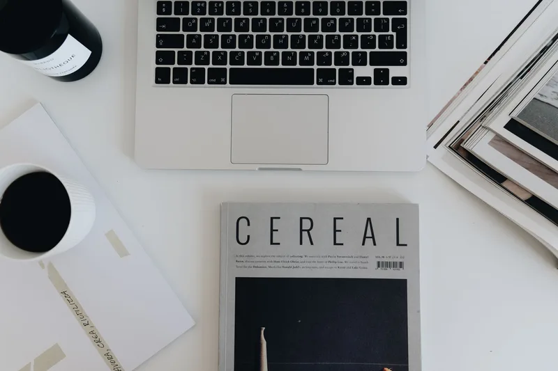Minimalist desk workspace with laptop and coffee, a productivity aesthetic