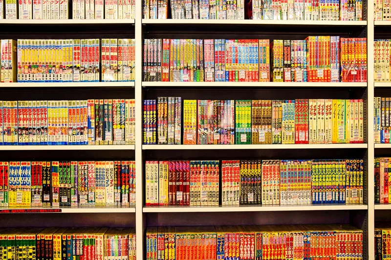 Bookshelf filled with manga volumes, representing the manga and light novel review format for faceless anime channels