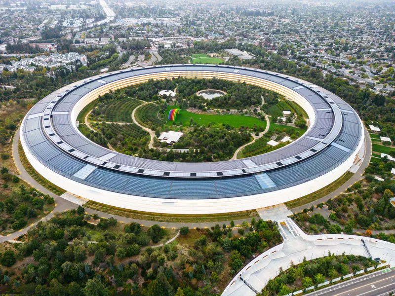 Aerial view of Apple Park in Cupertino, showcasing the circular design and scale of a modern corporate campus