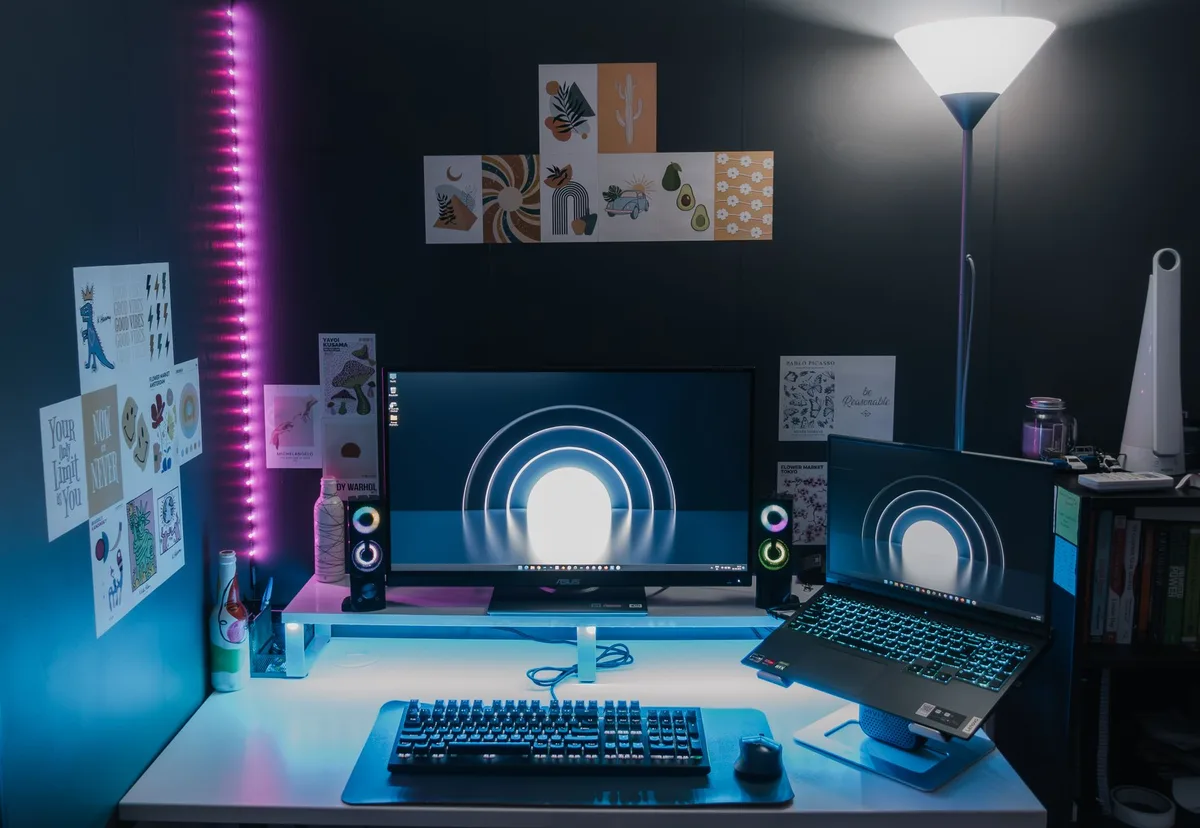 Stylish modern workspace with dual monitors displaying design software in a dimly lit room