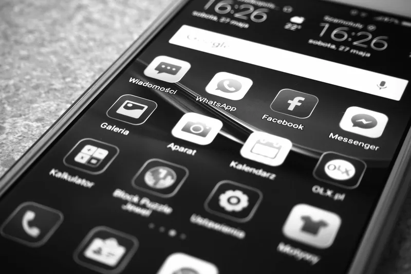 Abstract phone screen showing a bold-typography carousel post design with electric teal accents on dark background — no faces