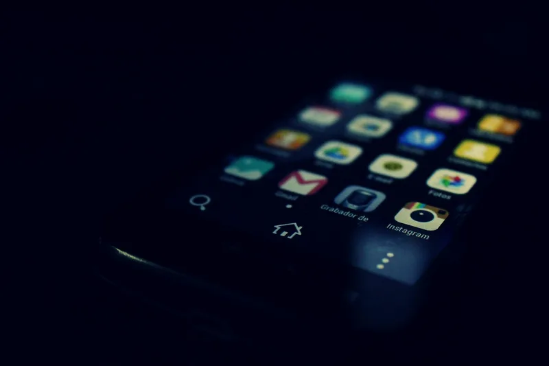 Dark minimal phone screen showing a cohesive Instagram grid aesthetic with consistent color palette and faceless content