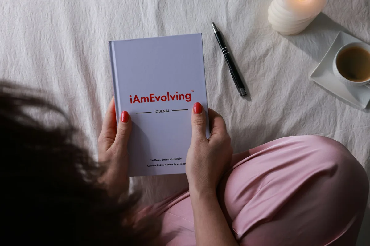 A person journaling by candlelight, the kind of quiet ritual footage that anchors manifestation content