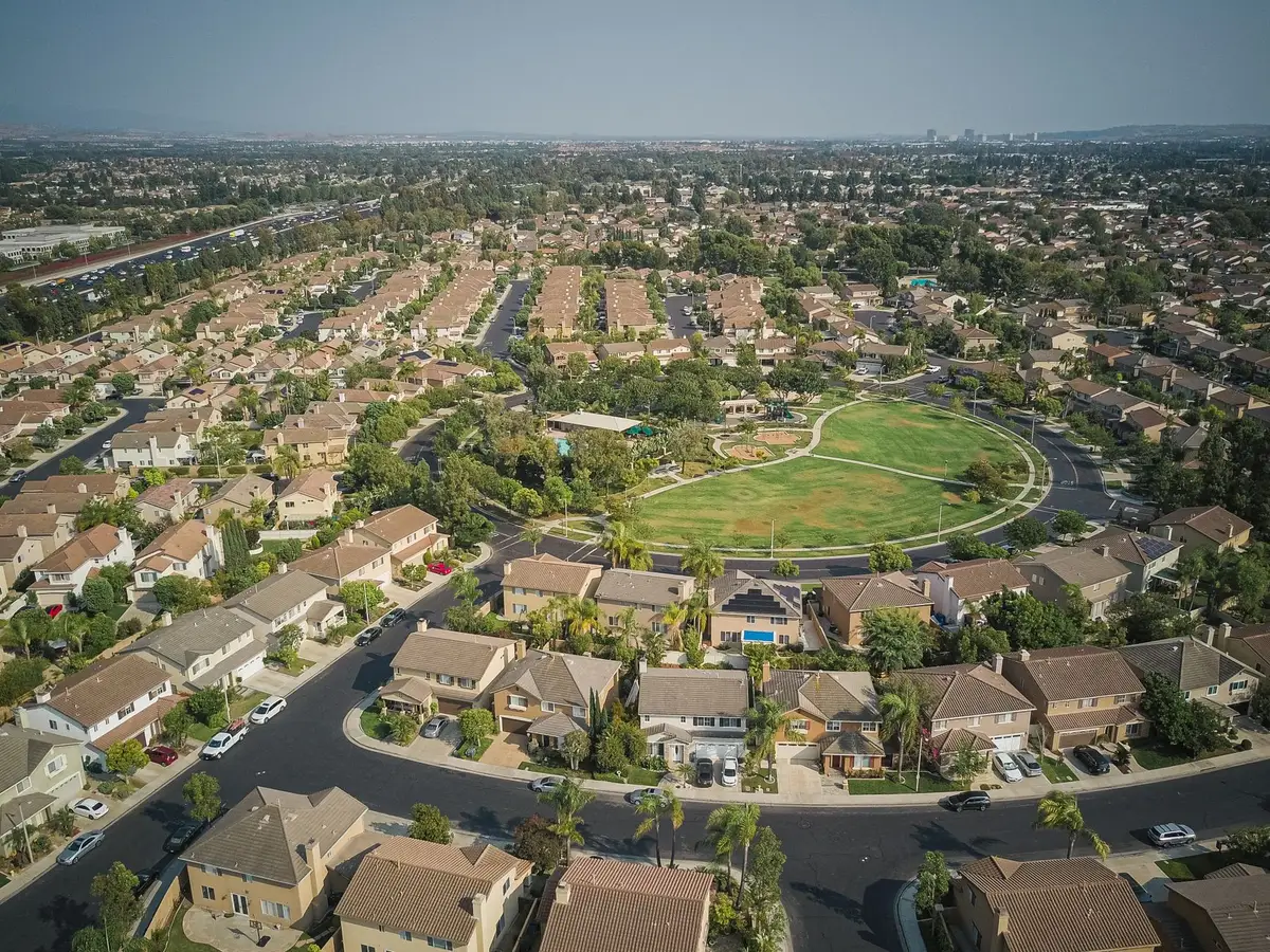 Aerial view of a residential neighborhood with rows of suburban homes