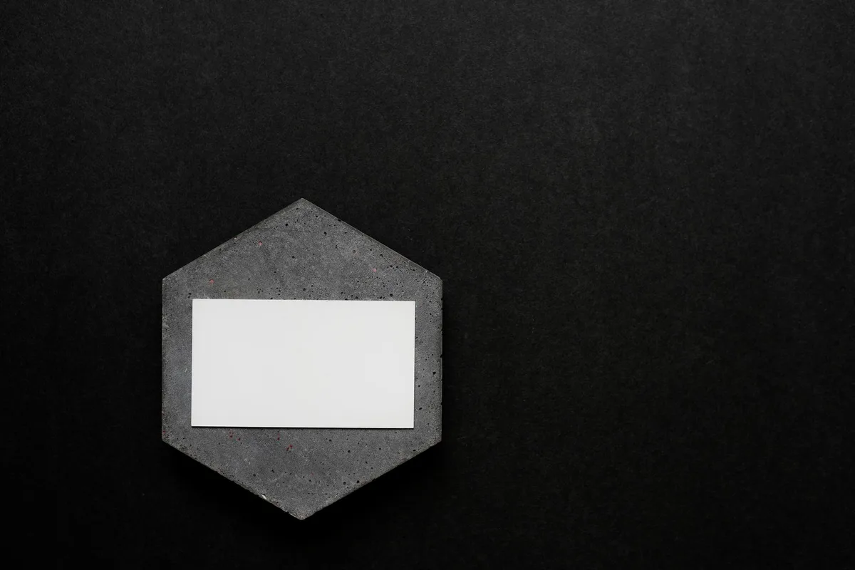 Minimalist branding mockup on dark surface representing YouTube channel identity