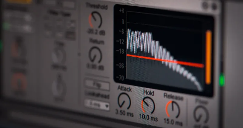 Close-up of a digital audio waveform interface with orange sound wave and mixing controls on a dark background