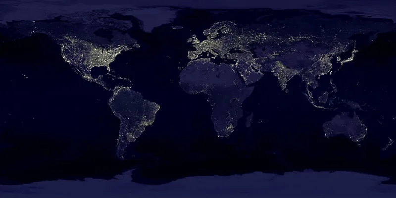 Satellite view of Earth at night with city lights across the continents