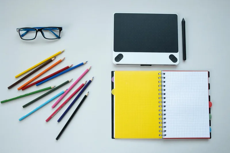 Creative workspace with graphic design tools and color materials representing thumbnail design process