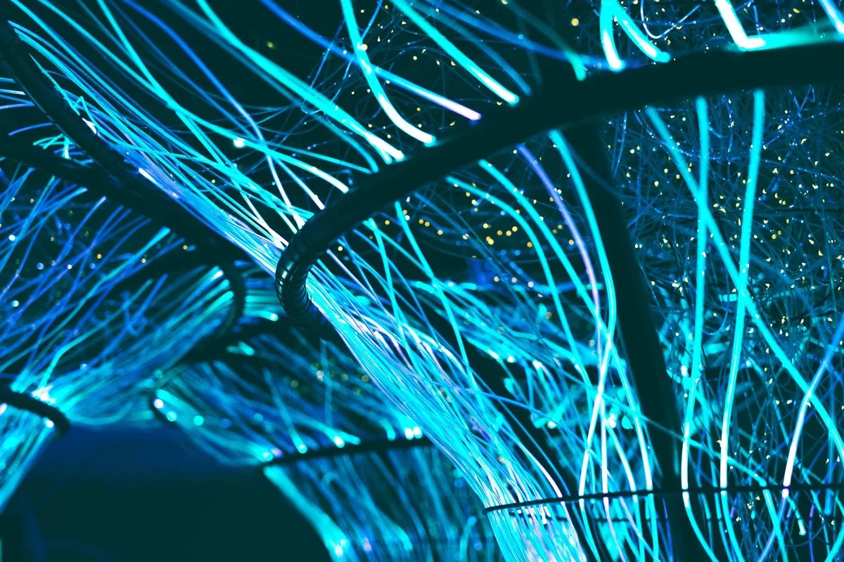 Glowing blue neon optical fibers representing AI-powered video generation technology
