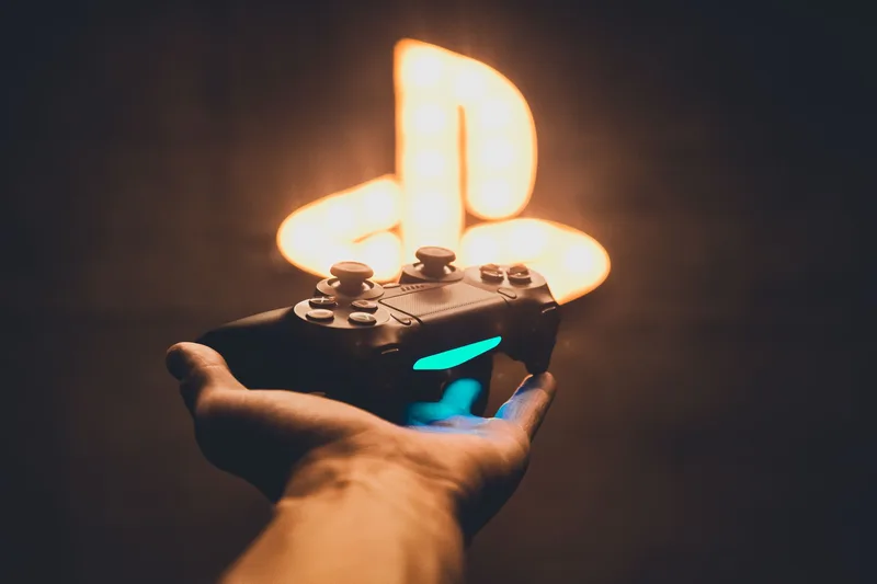 Hand holding a game controller, representing the low-CPM but high-volume gaming niche